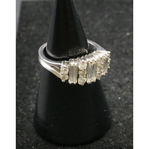 507 - A platinum ladies cluster ring set with 3 baguette diamonds interspersed with 10 further diamonds (c... 