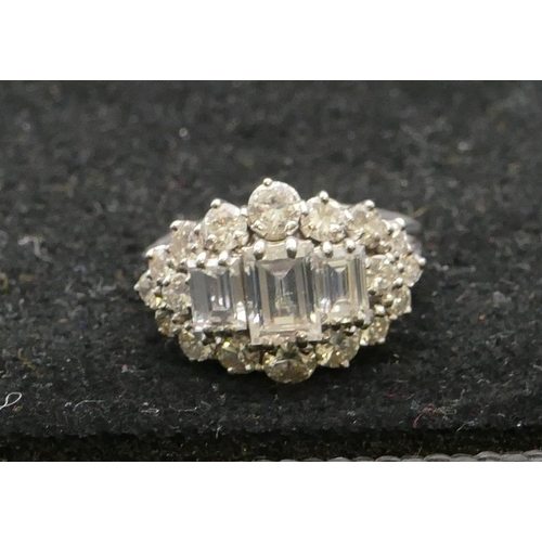 508 - A platinum ladies cluster ring set with 3 centre baguette cut diamonds and surrounded by 18 further ... 