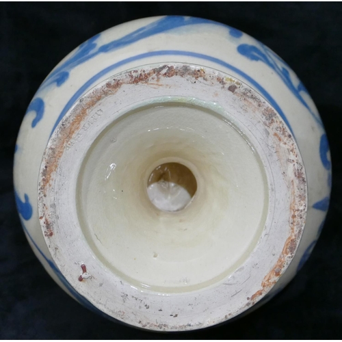 62 - A glazed slipware style round bulbous thin necked jug on white and turquoise ground with leaf and sc... 