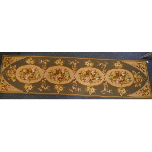 A rectangular tapestry/runner on grey ground with multicoloured rose