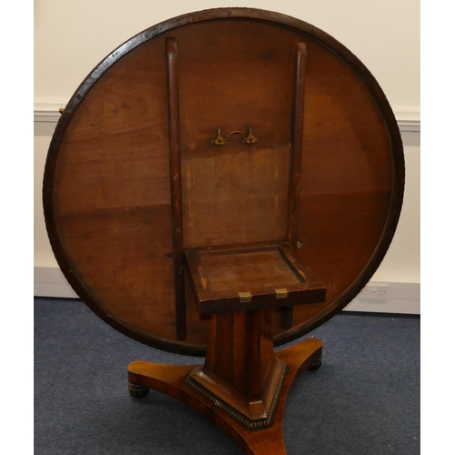 705 - A 19th Century rosewood round tilt top breakfast table on triangular stem with splayed base and flut... 