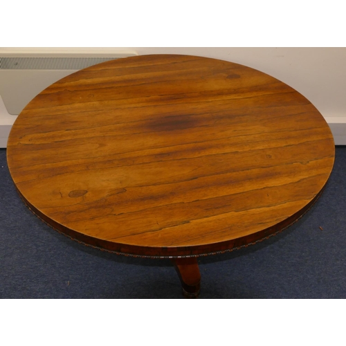 705 - A 19th Century rosewood round tilt top breakfast table on triangular stem with splayed base and flut... 