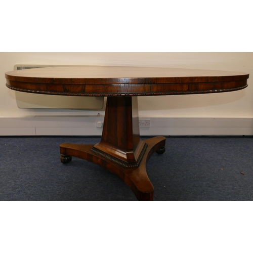 705 - A 19th Century rosewood round tilt top breakfast table on triangular stem with splayed base and flut... 