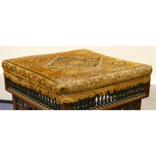 713 - An Eastern walnut square stool with overstuffed seat, turned finial frieze with part inlaid Mother o... 