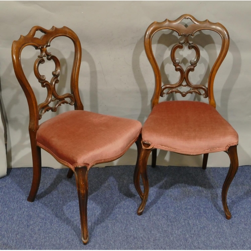 732 - A set of 6 Victorian walnut open back single chairs with pink overstuffed seats, on cabriole legs.