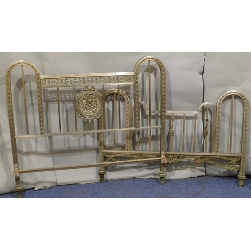 745 - A Spanish steel bedstead with centre embossed panel of cupids and allover pierced and raised shell, ... 