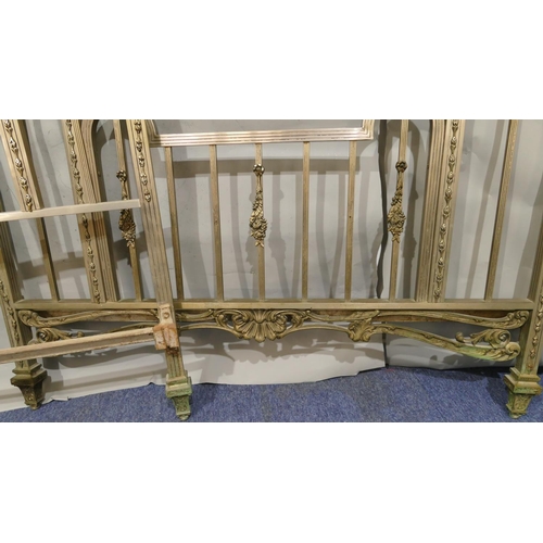 745 - A Spanish steel bedstead with centre embossed panel of cupids and allover pierced and raised shell, ... 