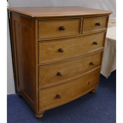 754 - A mahogany bow front chest of drawers, 2 small and 3 long drawers with wood knob handles and on turn... 