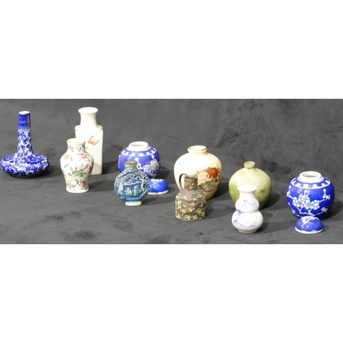 78 - A Cantonese miniature small round bulbous thin necked vase on white ground with multi-coloured butte... 