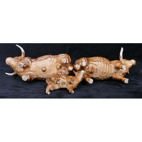 83 - A Beswick Highland bull with cow (Horn in need of restoration) and calf. (3)