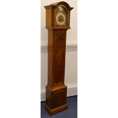 691 - A 1920's oak 8-day striking Westminster chime Grandmother clock with brass arched dial, Roman and Ar... 