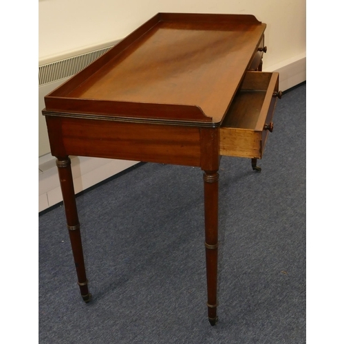 706 - A 19th Century mahogany side table with lipped back, 2 drawers with wood knob handles, round turned ... 