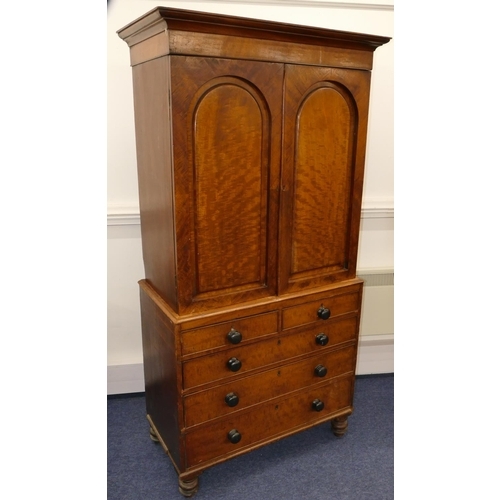 724 - A small 19th Century mahogany linen press with 2 arched panelled doors enclosing adjustable shelves,... 