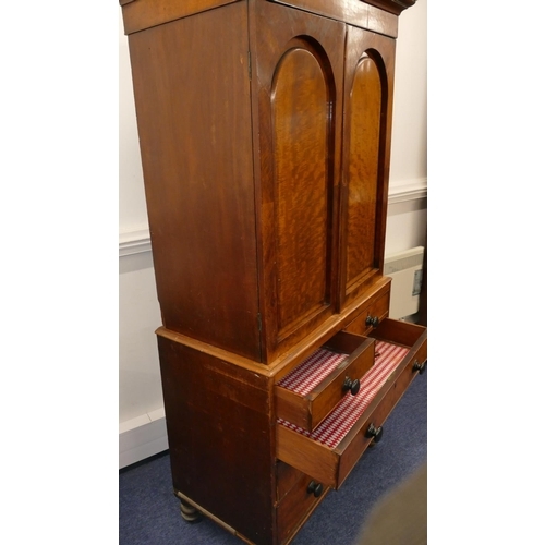 724 - A small 19th Century mahogany linen press with 2 arched panelled doors enclosing adjustable shelves,... 