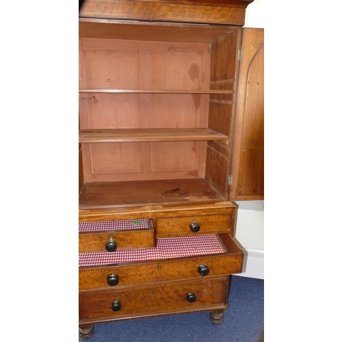 724 - A small 19th Century mahogany linen press with 2 arched panelled doors enclosing adjustable shelves,... 