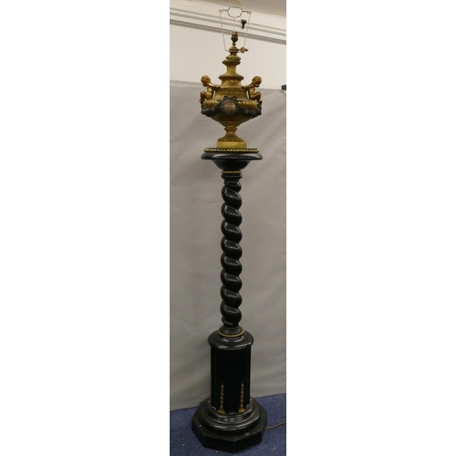 749 - A 19th Century ormolu and ebony standard lamp with urn motif and raised cupid, swag and floral decor... 