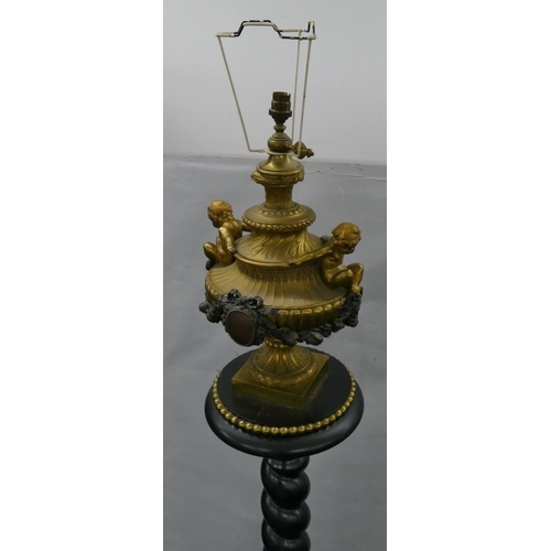 749 - A 19th Century ormolu and ebony standard lamp with urn motif and raised cupid, swag and floral decor... 