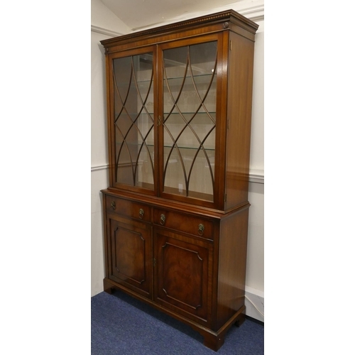 704 - A good quality reproduction mahogany display cabinet with 2 astrical glazed doors enclosing glass sh... 