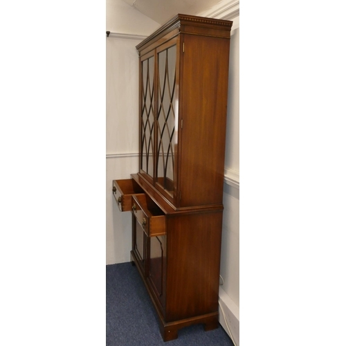 704 - A good quality reproduction mahogany display cabinet with 2 astrical glazed doors enclosing glass sh... 