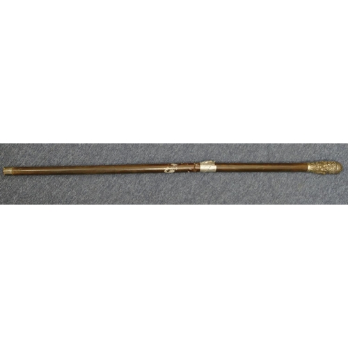 267 - An Eastern ebony staff with silver coloured metal top and all over embossed figure, floral and scrol... 