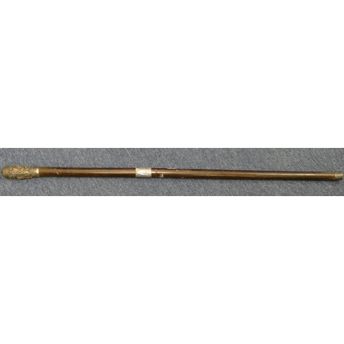 267 - An Eastern ebony staff with silver coloured metal top and all over embossed figure, floral and scrol... 