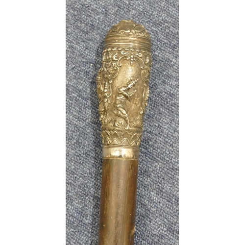 267 - An Eastern ebony staff with silver coloured metal top and all over embossed figure, floral and scrol... 