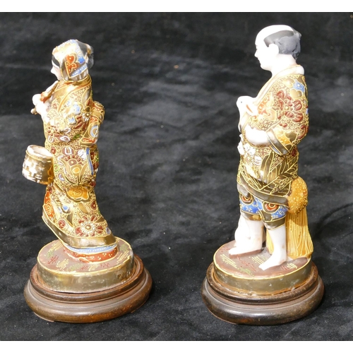 34 - A pair of Oriental figures of gentleman and lady with allover gilt decoration, on round wooden  base... 