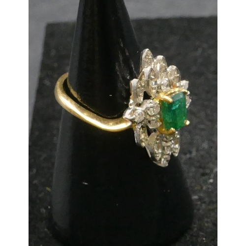 500 - A high carat yellow gold cluster ring set with centre emerald and surrounded by small diamonds, size... 