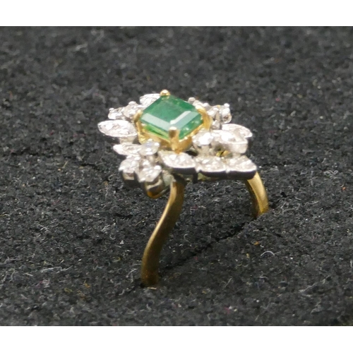 500 - A high carat yellow gold cluster ring set with centre emerald and surrounded by small diamonds, size... 