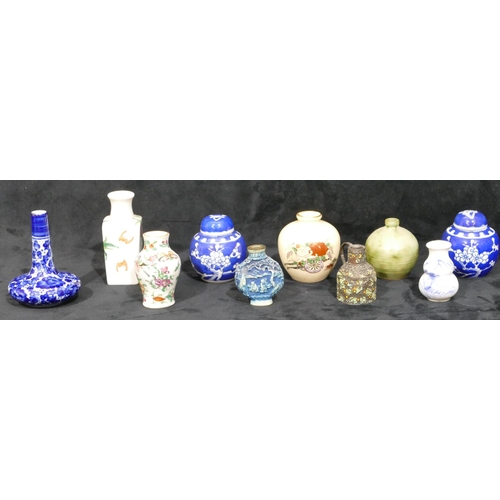 78 - A Cantonese miniature small round bulbous thin necked vase on white ground with multi-coloured butte... 