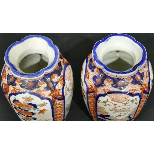1 - A pair of Imari round bulbous thin necked vases on white, red and blue ground with allover floral, l... 