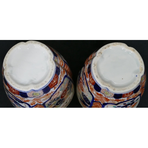 1 - A pair of Imari round bulbous thin necked vases on white, red and blue ground with allover floral, l... 