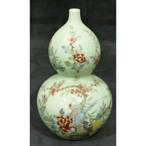 139 - An Oriental double gould vase on pale green ground with multi-coloured bird, branch, floral and leaf... 