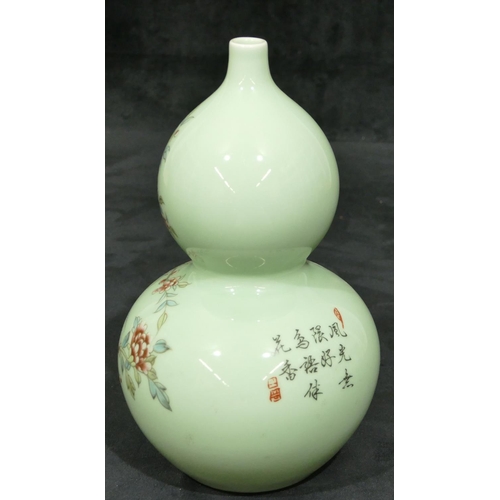 139 - An Oriental double gould vase on pale green ground with multi-coloured bird, branch, floral and leaf... 