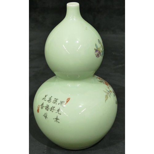 139 - An Oriental double gould vase on pale green ground with multi-coloured bird, branch, floral and leaf... 