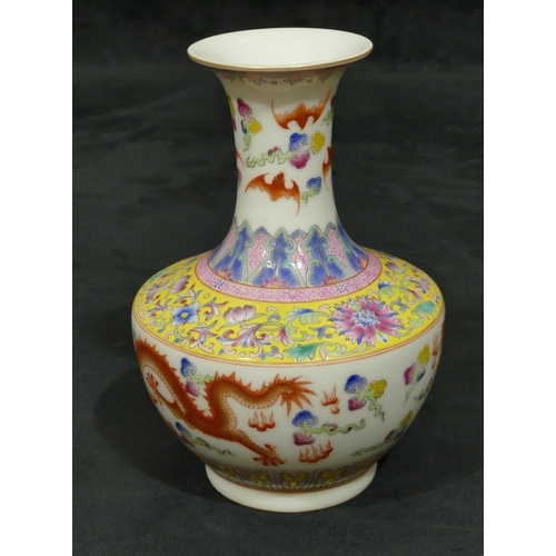 140 - An Oriental round bulbous thin necked trumpet shaped vase on white ground with multi-coloured dragon... 