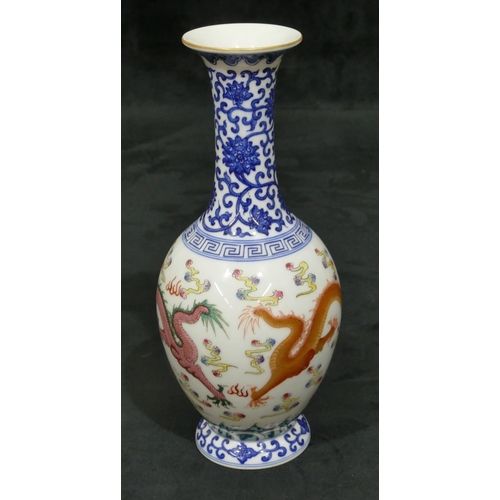 141 - An Oriental round bulbous thin necked trumpet shaped vase on white and blue ground with multi-colour... 