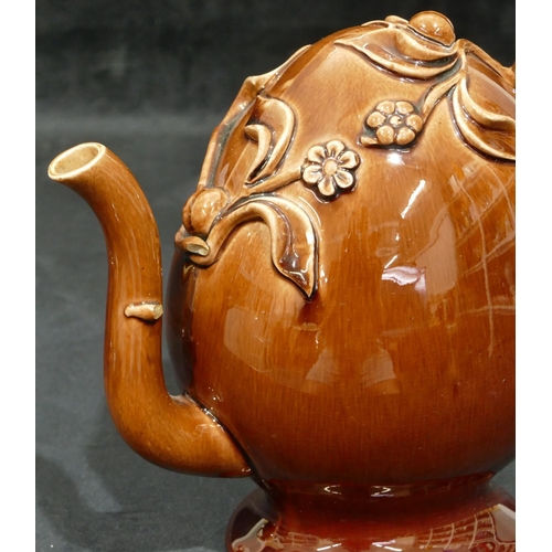 151 - 2 Treacle ware puzzle teapots with raised floral and leaf decoration, largest 20.5cm high (smallest ... 