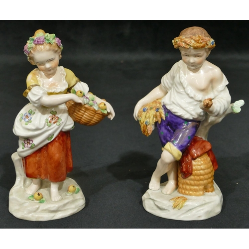 158 - A pair of Sitzendorf porcelain figures of young boy and girl holding baskets encrusted with fruit an... 