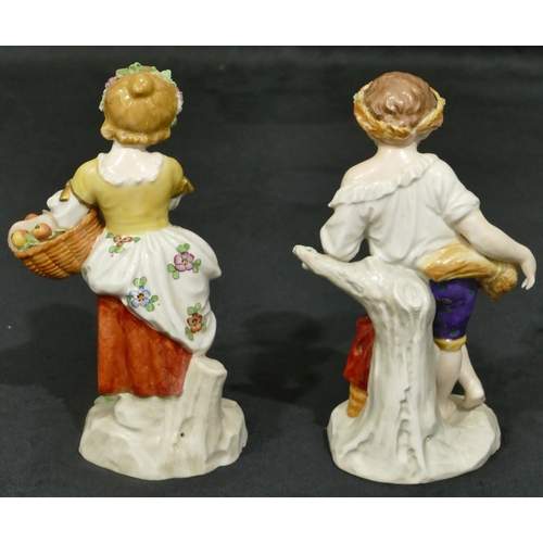 158 - A pair of Sitzendorf porcelain figures of young boy and girl holding baskets encrusted with fruit an... 