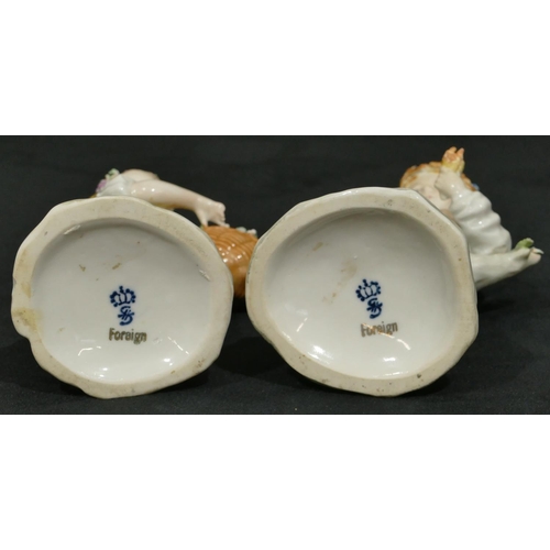 158 - A pair of Sitzendorf porcelain figures of young boy and girl holding baskets encrusted with fruit an... 