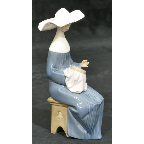 165 - A Lladro figure of a seated Nun sewing,20cm high