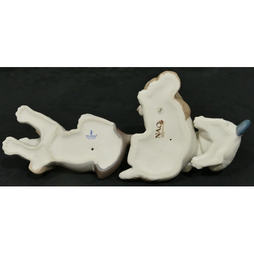 167 - A Lladro figure of a puppy on white and brown ground, 17cm wide, a Nao group of 2 puppies (2)