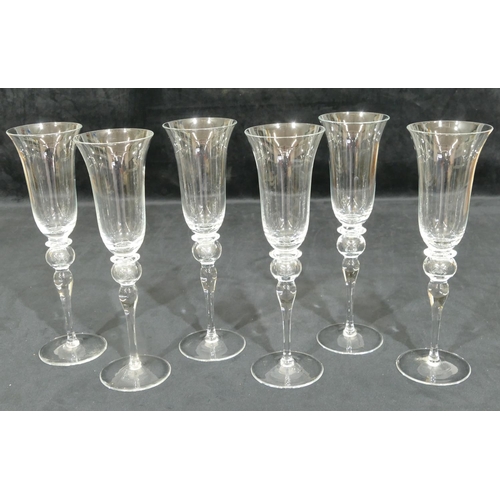 184 - A set of 6 Murano clear glass round trumpet shaped champagne flutes on bulbous stems with round base... 