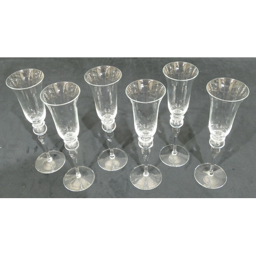 184 - A set of 6 Murano clear glass round trumpet shaped champagne flutes on bulbous stems with round base... 