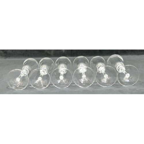 184 - A set of 6 Murano clear glass round trumpet shaped champagne flutes on bulbous stems with round base... 