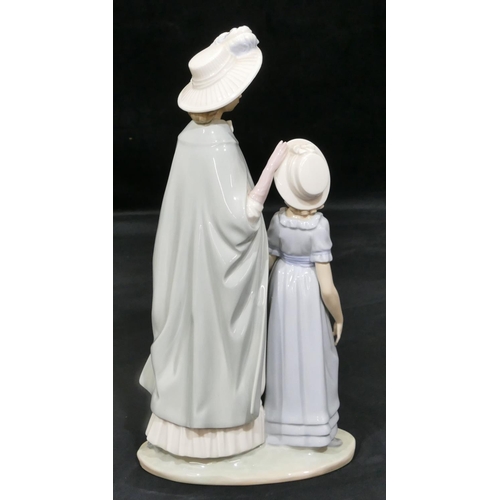 26 - A Nao group of standing mother and young girl, 37.5cm high