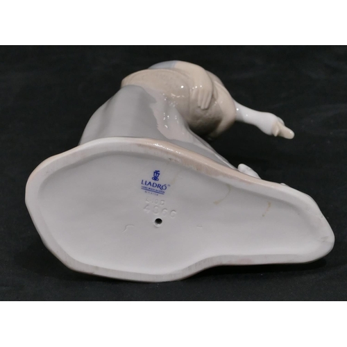 4 - A Lladro figure of a lady holding a bird with puppy at her feet, 27.5cm high.