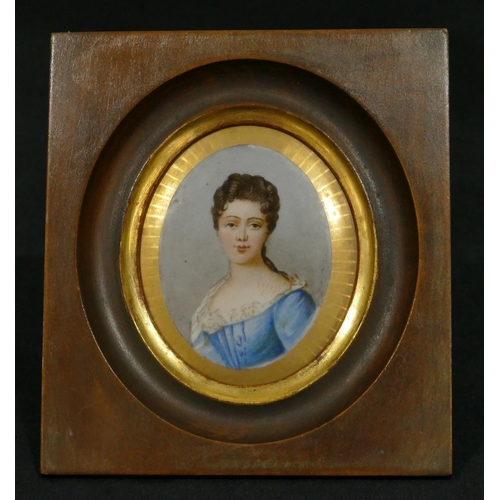 65 - An oval porcelain plaque shoulder length portrait of a lady in fruitwood frame (plaque 8.5cm x 7cm)