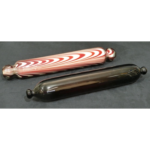 66 - A clear and ruby glass rolling pin, 37cm long, a 19th Century brown glass rolling pin, 35cm long (2)